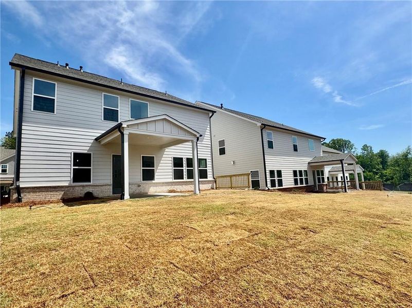 Exterior details and patio area of a home in Eastlyn Crossing, Flowery Branch (Image 4).