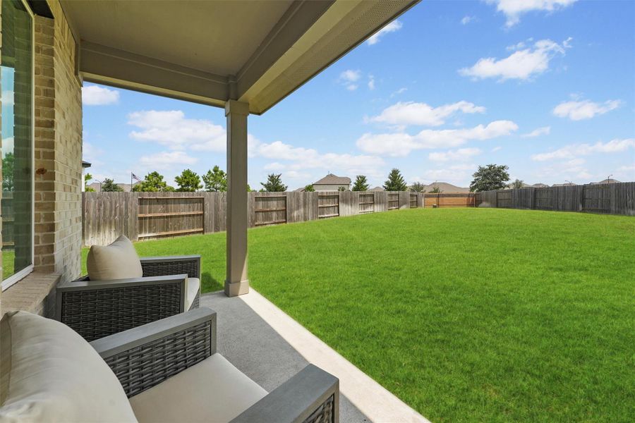 Step outside to a spacious covered patio that overlooks one of the largest backyards in the neighborhood. The vast outdoor space is perfect for relaxing, entertaining, or for a future pool or play area.
