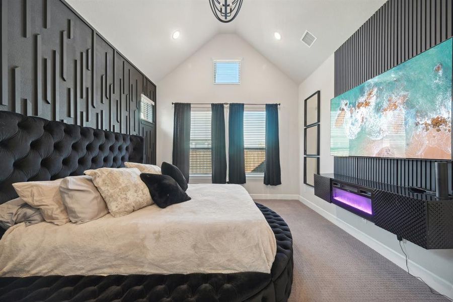 Carpeted bedroom featuring vaulted ceiling