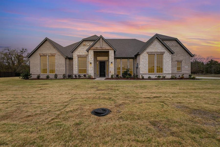 French provincial home featuring a yard