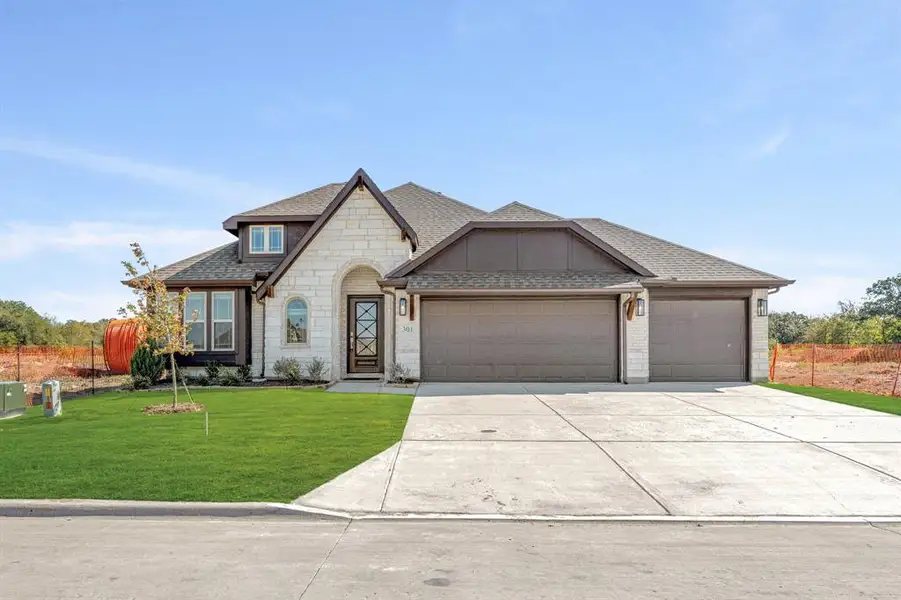 Front exterior of a new home in East Oak Creek 60-65, Commerce, TX, highlighting curb appeal (Image 2).