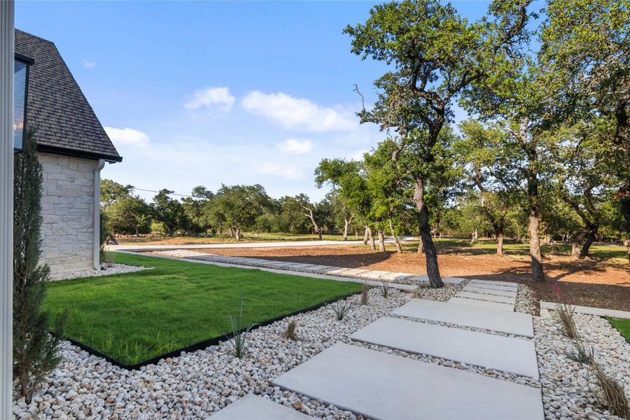 Front exterior of a new home in , Dripping Springs, TX, highlighting curb appeal (Image 22). Front exterior of a new home in , Dripping Springs, TX, highlighting curb appeal (Image 22).
