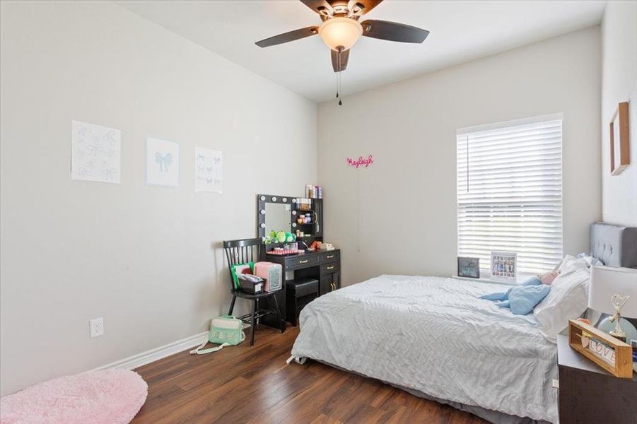 Bedroom with wood finished floors and ceiling fan
