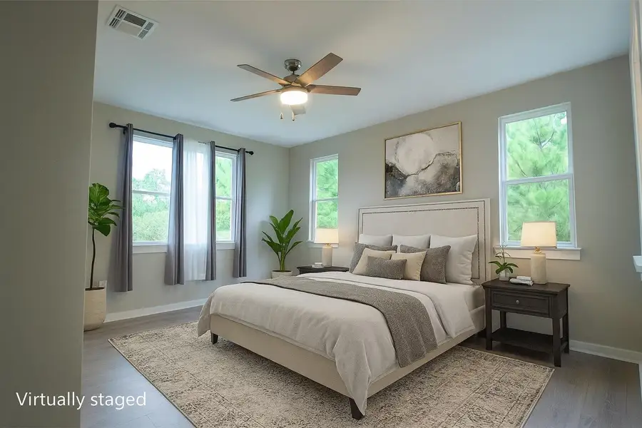 Primary Bedroom featuring ceiling fan and wood finished floors