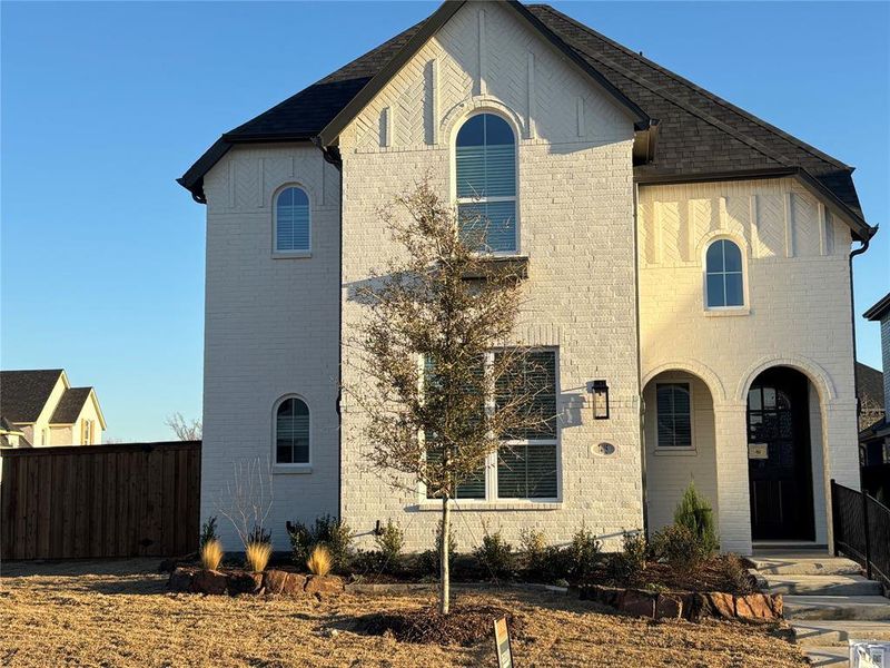 Front exterior of a new home in Aster Park, McKinney, TX, highlighting curb appeal (Image 2).