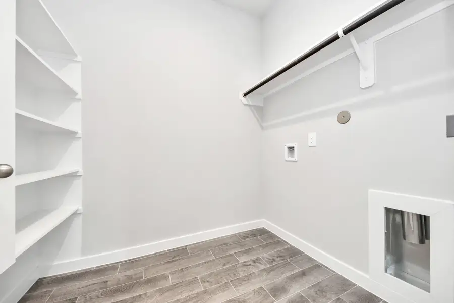 A perfect blend of functionality and comfort. Capture the essence of easy living with a first-floor laundry room, thoughtfully equipped with shelving for effortless organization. Both electric and gas connections available. Sample photo of completed home with similar floor plan. Actual colors and selections may vary. A perfect blend of functionality and comfort. Capture the essence of easy living with a first-floor laundry room, thoughtfully equipped with shelving for effortless organization. Both electric and gas connections available. Sample photo of completed home with similar floor plan. Actual colors and selections may vary.