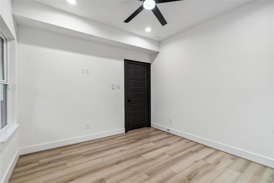 With ample space and natural light, this secondary bedroom offers easy access to the backyard, providing the perfect setting for relaxation or an invigorating home office environment