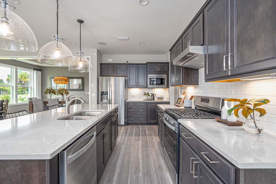 Double ovens with cooktop and range hood, as well as a microwave complete the new construction kitchen