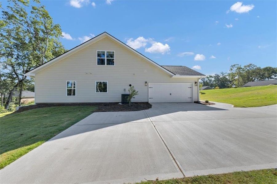 Front exterior of a new home in Tuscany Hills, Douglasville, GA, highlighting curb appeal (Image 24).
