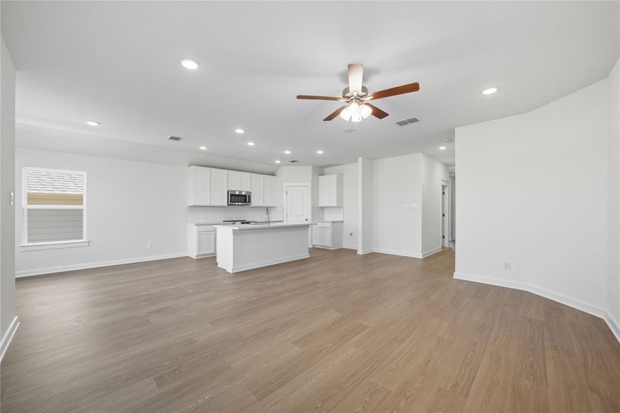 Unfurnished living room featuring light wood-type flooring, recessed lighting, and ceiling fan