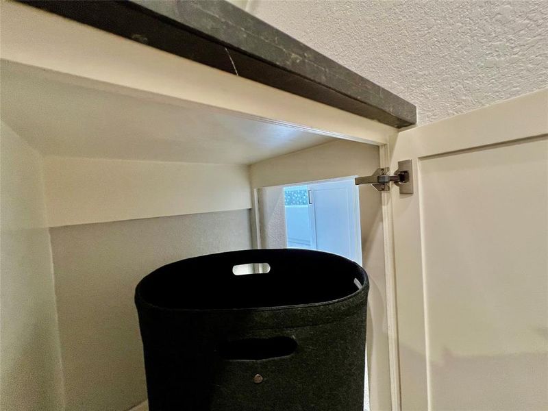 hidden laundry drop from primary closet to laundry room