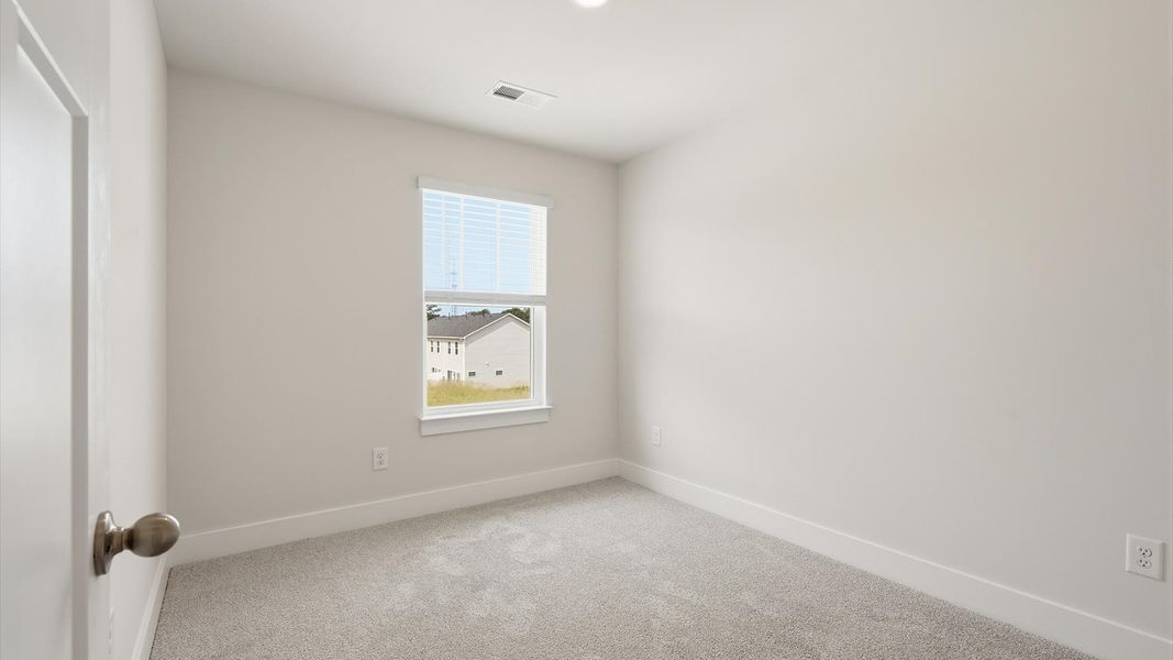 Vibrant and restful bedroom with an oversized window, refined detail, and a warm, welcoming atmosphere by DRB Homes