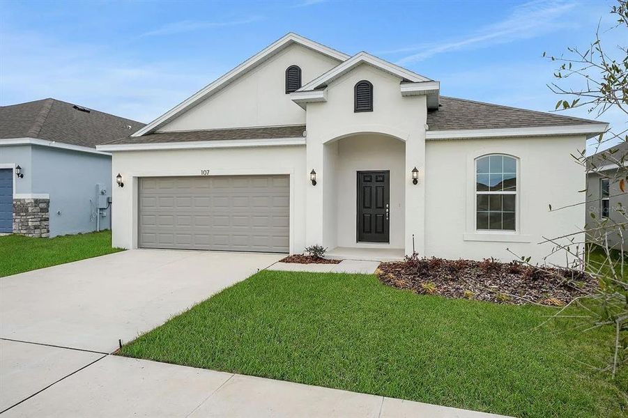 Front exterior of a new home in Cypress Park Estates, Haines City, FL, highlighting curb appeal (Image 22).