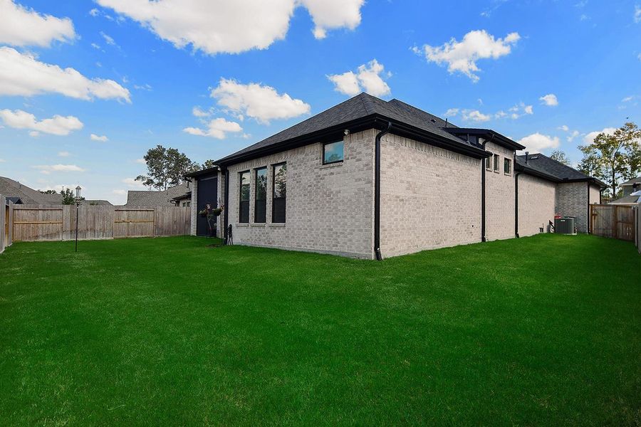 Exterior details and patio area of a home in The Highlands - 65', Porter (Image 3). Exterior details and patio area of a home in The Highlands - 65', Porter (Image 3).