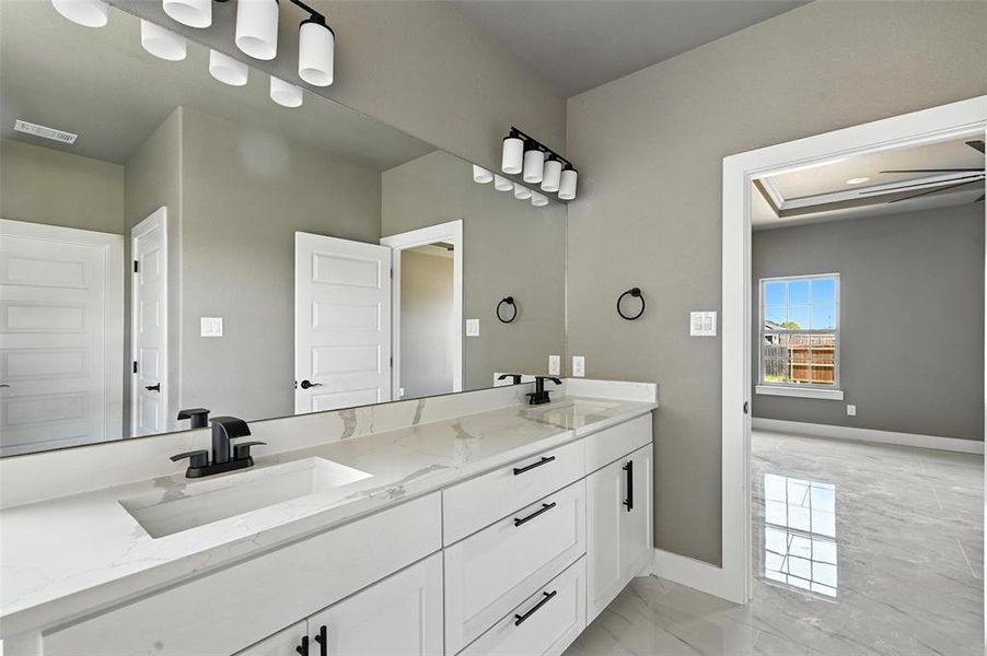 Bathroom with marble finish floors and double vanity Bathroom with marble finish floors and double vanity