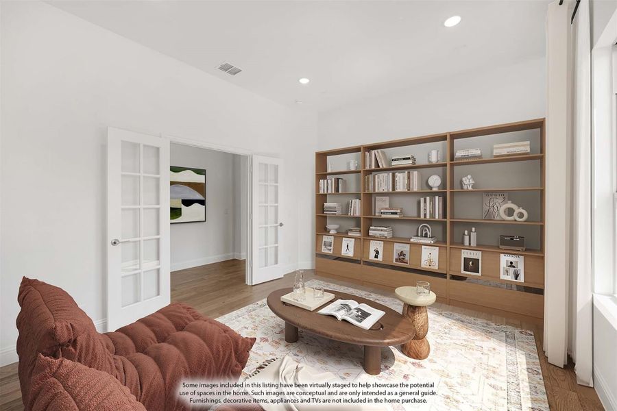 Sitting room with built-in wood bookshelf, French doors, and hardwood floors