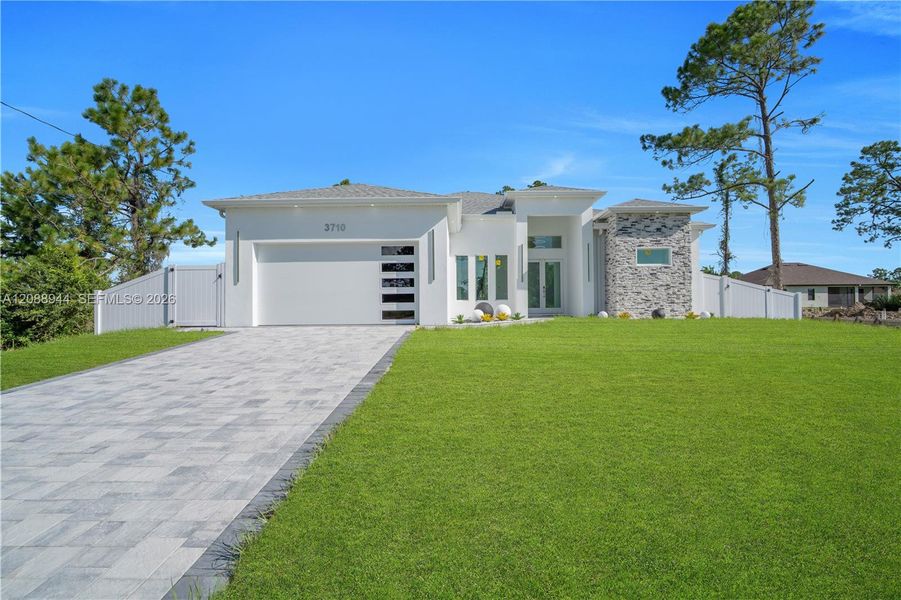 Front exterior of a new home in , Lehigh Acres, FL, highlighting curb appeal (Image 27).