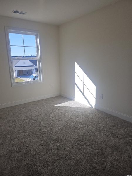 Unfurnished room with carpet floors and baseboards