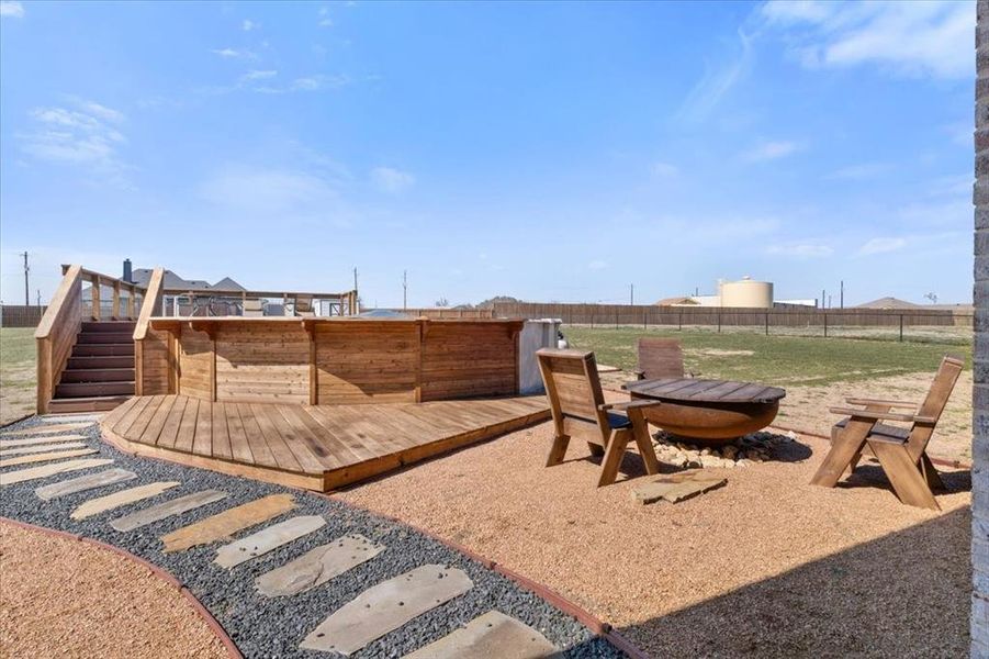 View of yard with stairway, fence, and a wooden deck