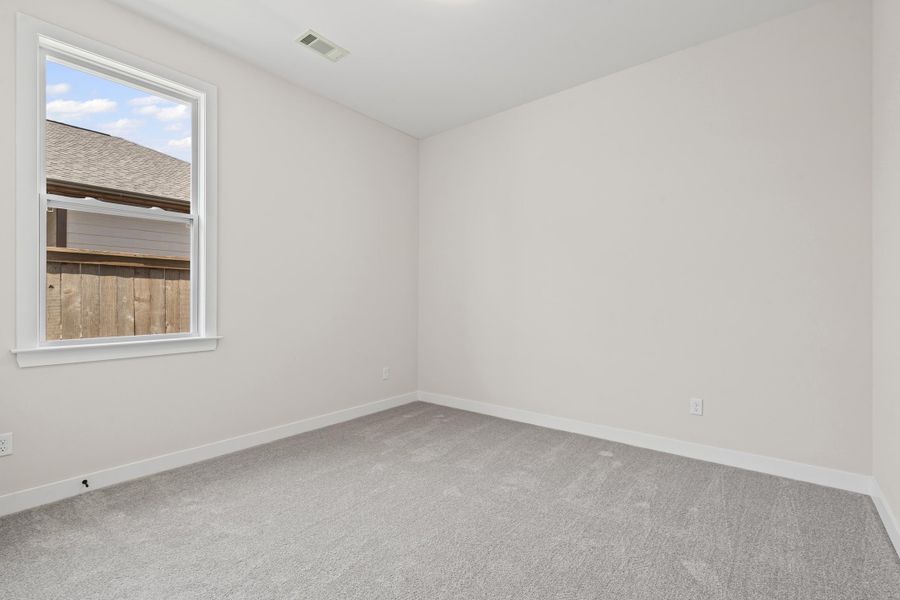 Spare room featuring baseboards and light colored carpet Spare room featuring baseboards and light colored carpet