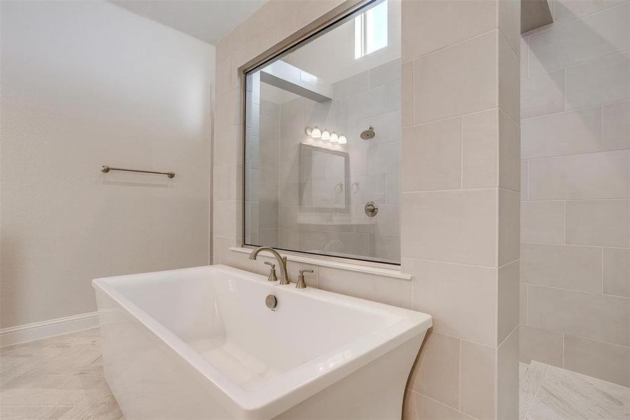 Bathroom featuring shower with separate bathtub