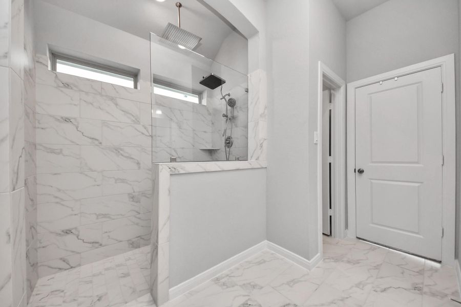 Huge walk in title surround shower with a spa rain showerhead to relax.