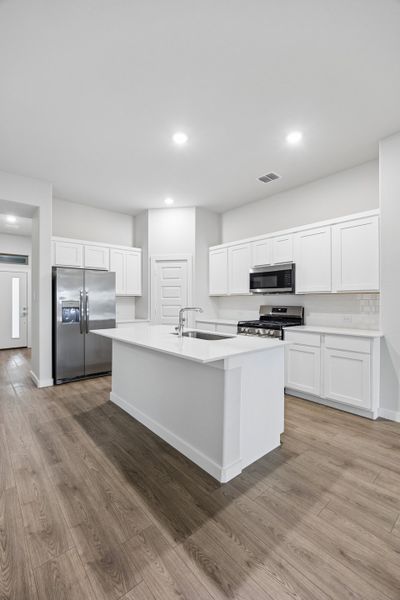 Kitchen in the Cedar home plan by Trophy Signature Homes – REPRESENTATIVE PHOTO