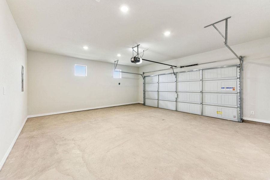 Garage featuring recessed lighting and a garage door opener