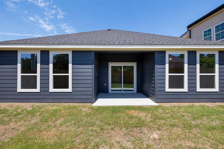 Rear view of house with a lawn