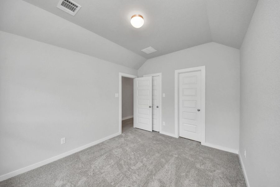 Generously sized secondary bedrooms featuring spacious closets, soft and inviting carpeting underfoot, large windows allowing plenty of natural light, and the added touch of privacy blinds for your personal retreat. Sample photo of completed home with similar floor plan. Actual colors and selections may vary.