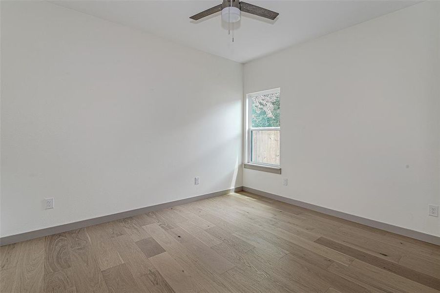 Spare room with light wood-style flooring and ceiling fan
