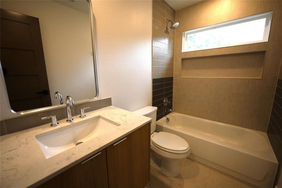 Bathroom with shower / washtub combination and vanity