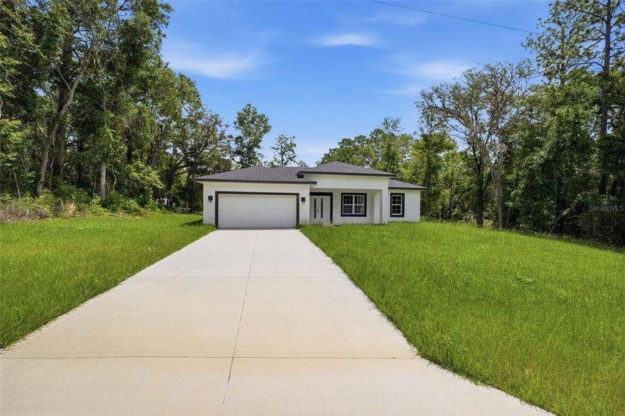 Front exterior of a new home in , Citrus Springs, FL, highlighting curb appeal (Image 18).