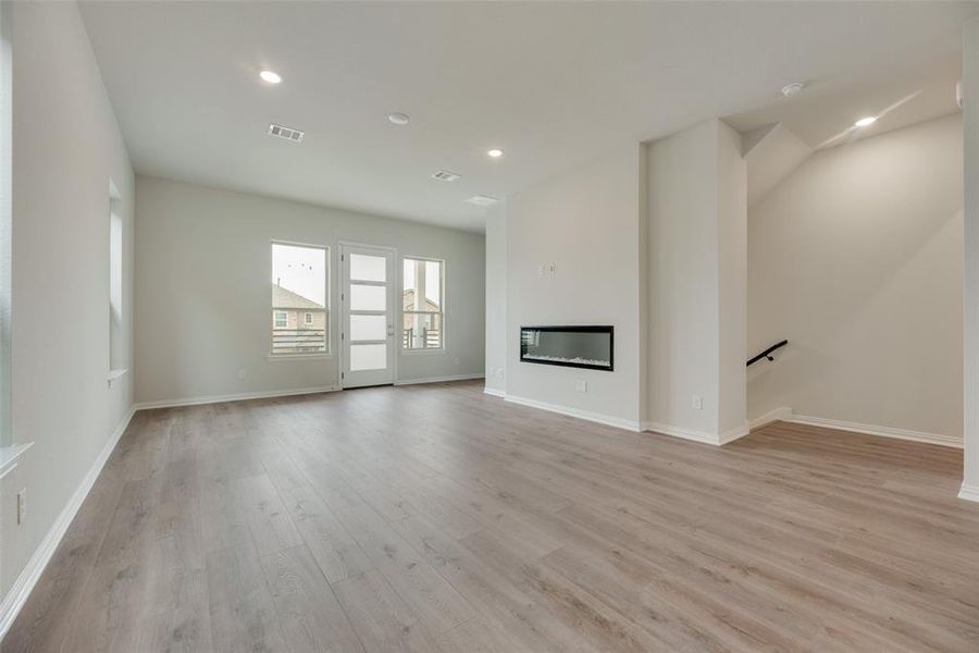 Unfurnished living room with light hardwood / wood-style floors