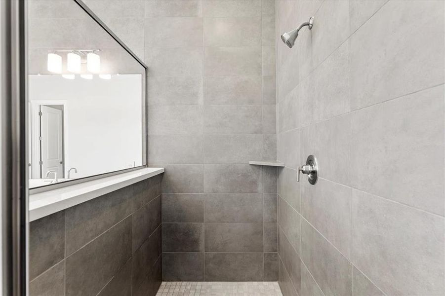 Bathroom featuring a tile shower