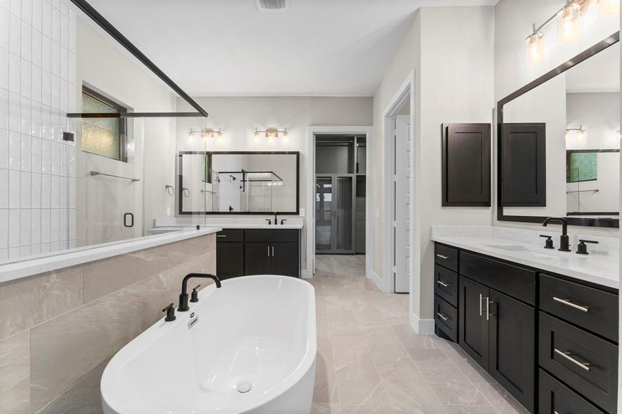 Experience the epitome of elegance in the expansive primary bathroom, complete with a luxurious soaking tub, double vanities, and a walk-through shower.