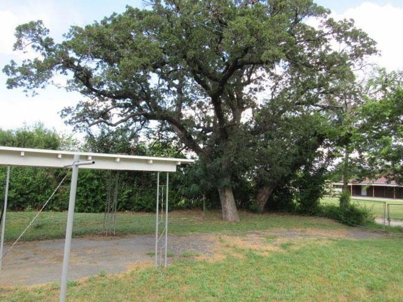 View of yard featuring a detached carport View of yard featuring a detached carport