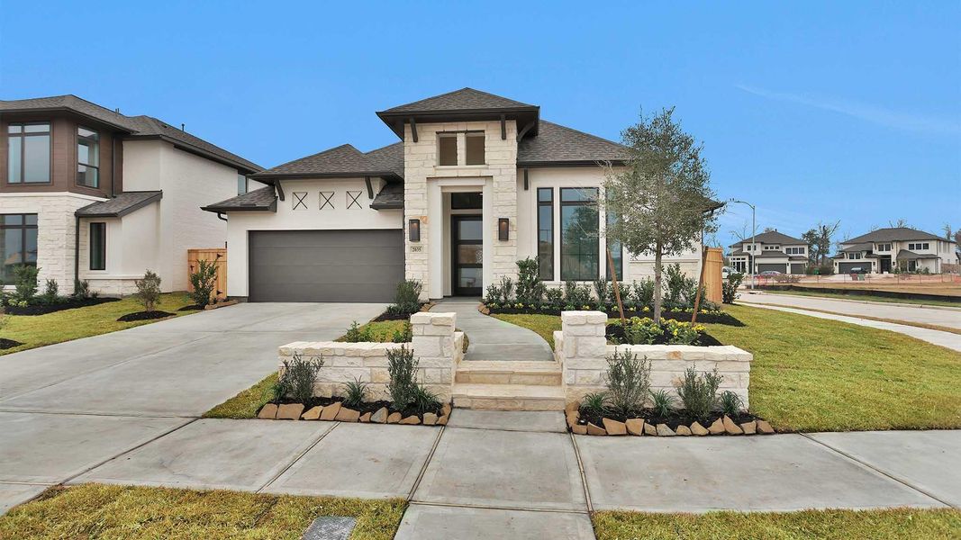 Front exterior of a new home in Sienna, Missouri City, TX, highlighting curb appeal (Image 2).