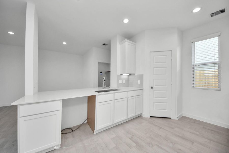 All of this overlooks your expansive family room, creating a perfect space for culinary delights and family gatherings. Sample photo of completed home with similar floor plan. Actual colors and selections may vary.