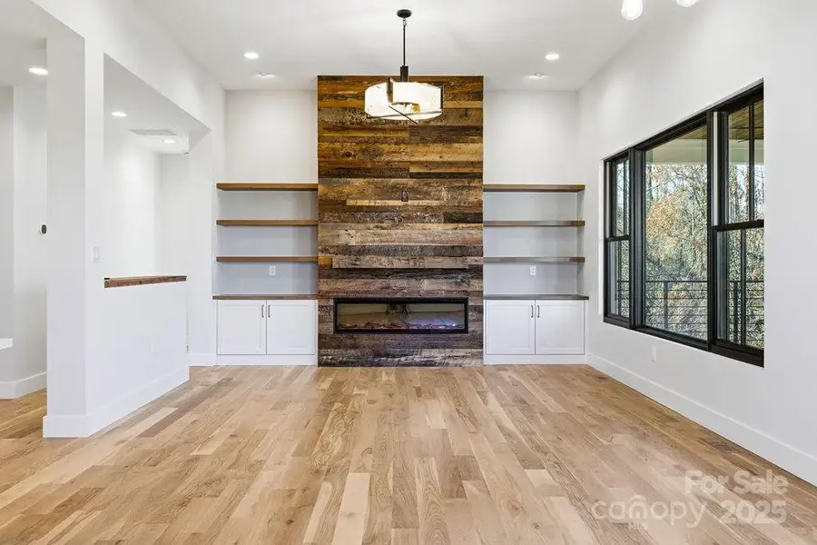 Dramatic floor-to-ceiling fireplace with custom built-ins