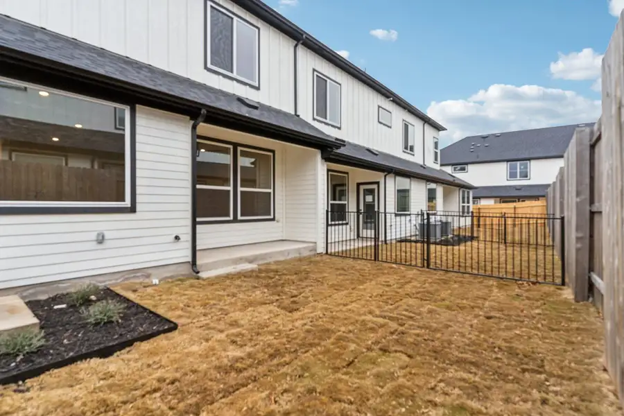 Exterior details and patio area of a home in Townhomes at Gattis, Round Rock (Image 4).