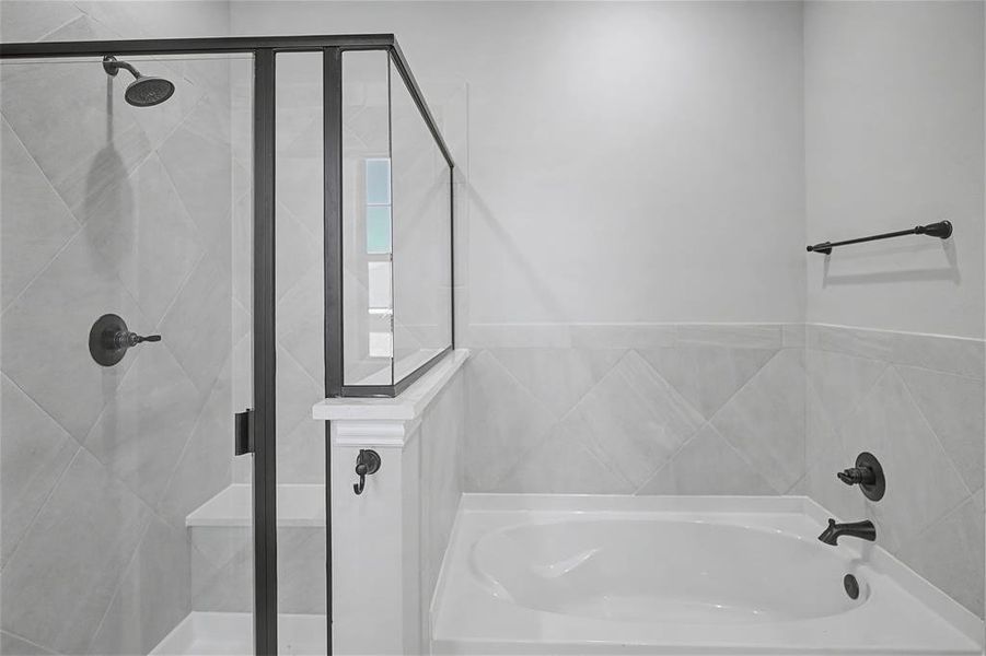 Bathroom featuring a shower stall and a bath