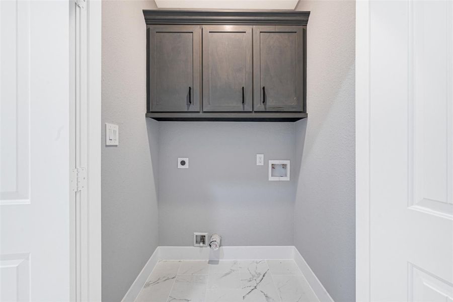 Utility room on the first floor with extra cabinet storage space