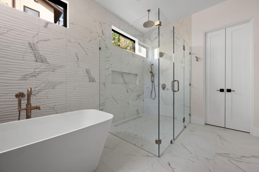The walk-in shower features premium tilework and elite fixtures, evoking the ambiance of a five-star resort