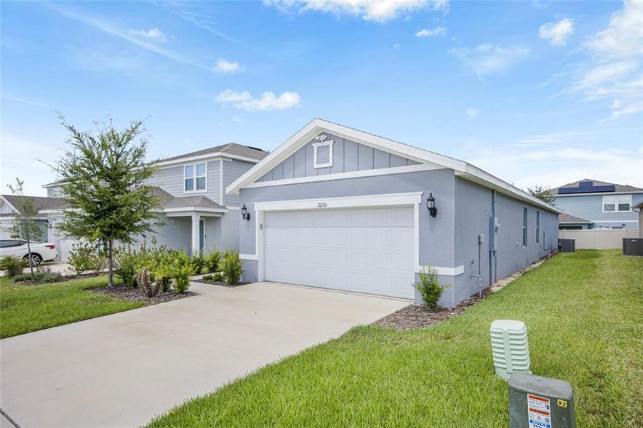 Front exterior of a new home in Belle Haven, Davenport, FL, highlighting curb appeal (Image 22). Front exterior of a new home in Belle Haven, Davenport, FL, highlighting curb appeal (Image 22).