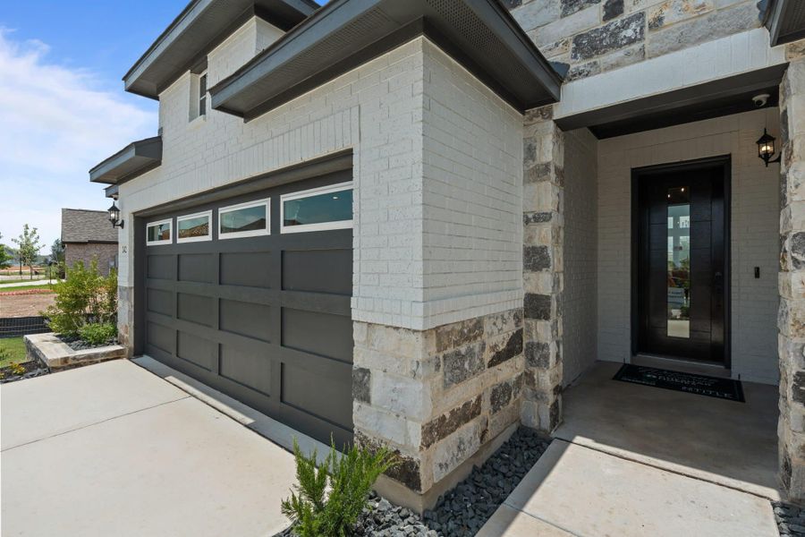 Front exterior of a new home in Alsatian Oaks, Castroville, TX, highlighting curb appeal (Image 10). Front exterior of a new home in Alsatian Oaks, Castroville, TX, highlighting curb appeal (Image 10).