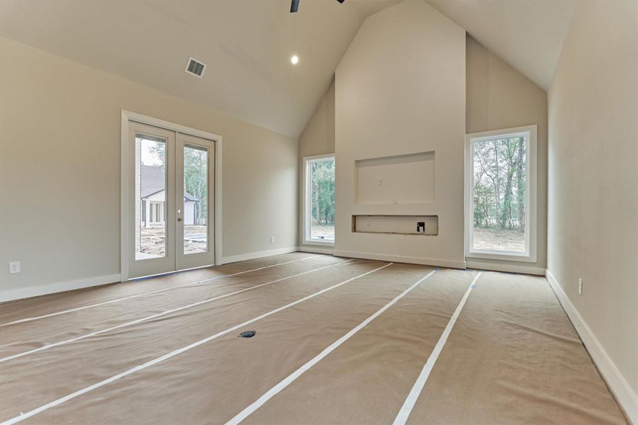 Private en-suite bath featuring a navy vanity with quartz countertops, modern lighting, and a sleek tiled shower—perfect for a comfortable secondary suite.