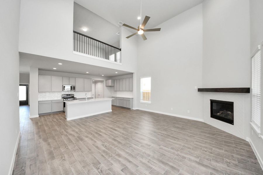 Family room flooded with natural light through the expansive windows. The premium tile flooring adds a touch of luxury to the space, creating the perfect setting for relaxing moments and cherished gatherings with loved ones Family room flooded with natural light through the expansive windows. The premium tile flooring adds a touch of luxury to the space, creating the perfect setting for relaxing moments and cherished gatherings with loved ones