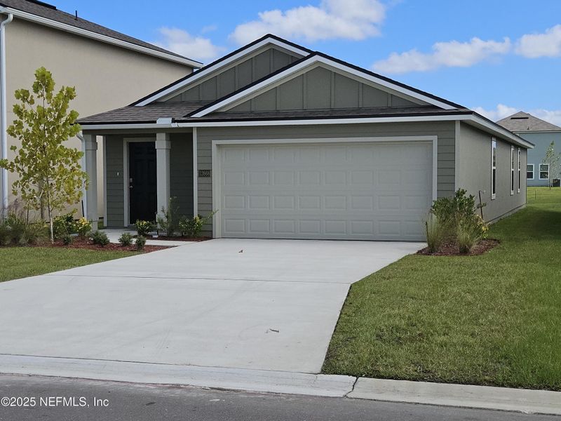 Front exterior of a new home in The Arbors, Jacksonville, FL, highlighting curb appeal (Image 1).