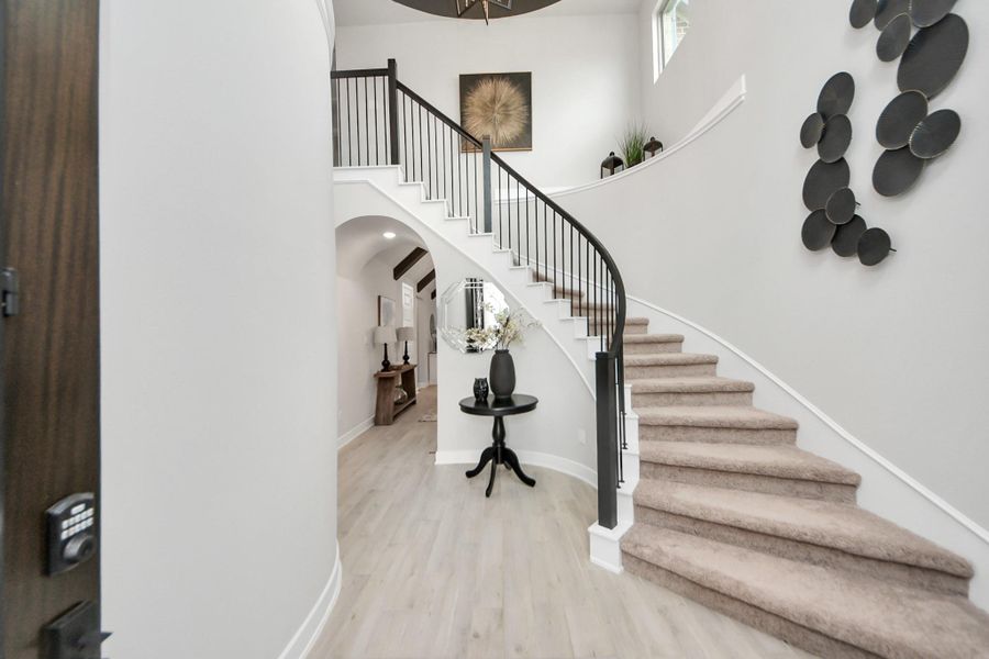 WELCOME HOME! Elegant foyer with curved staircase set the tone!